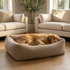 Beige corduroy orthopaedic pet bed with cushioned bolsters and textured fabric; brown dog resting